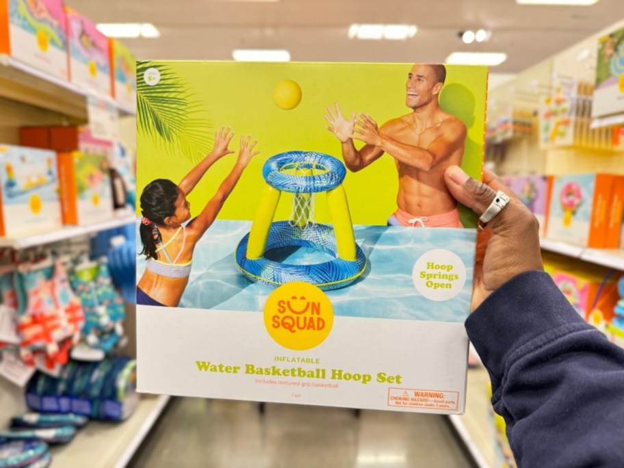 hand holding a package with a pool basketball game float