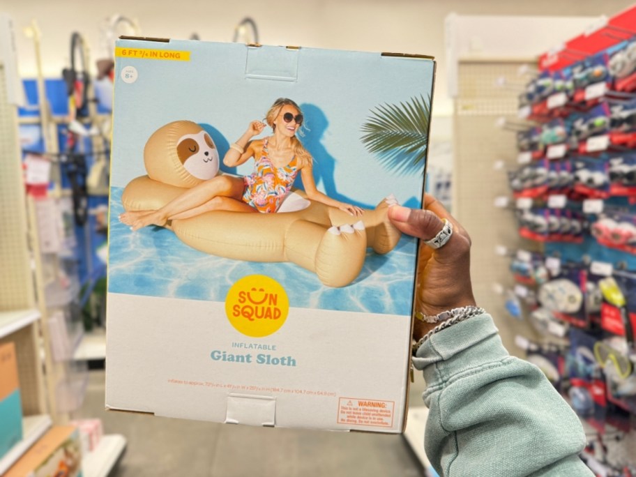 hand holding a package for a giant Sloth Pool Float 