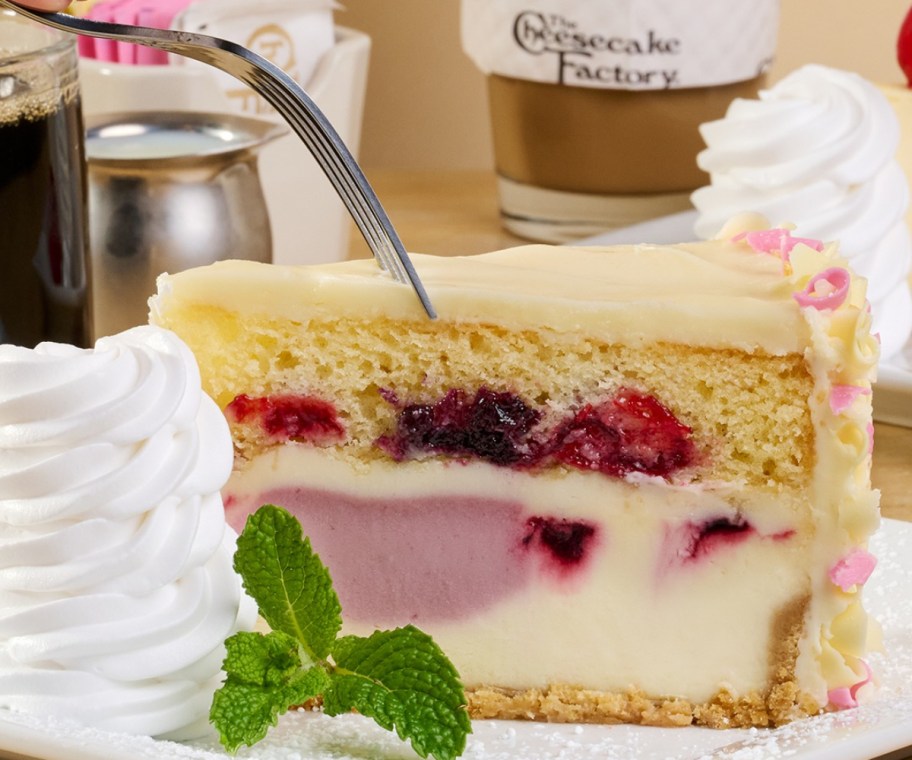 putting a fork into a slice of cheesecake