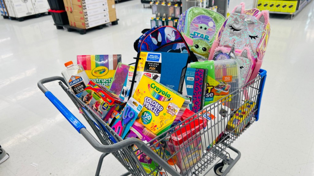 walmart cart full of school supplies in the middle of an aisle