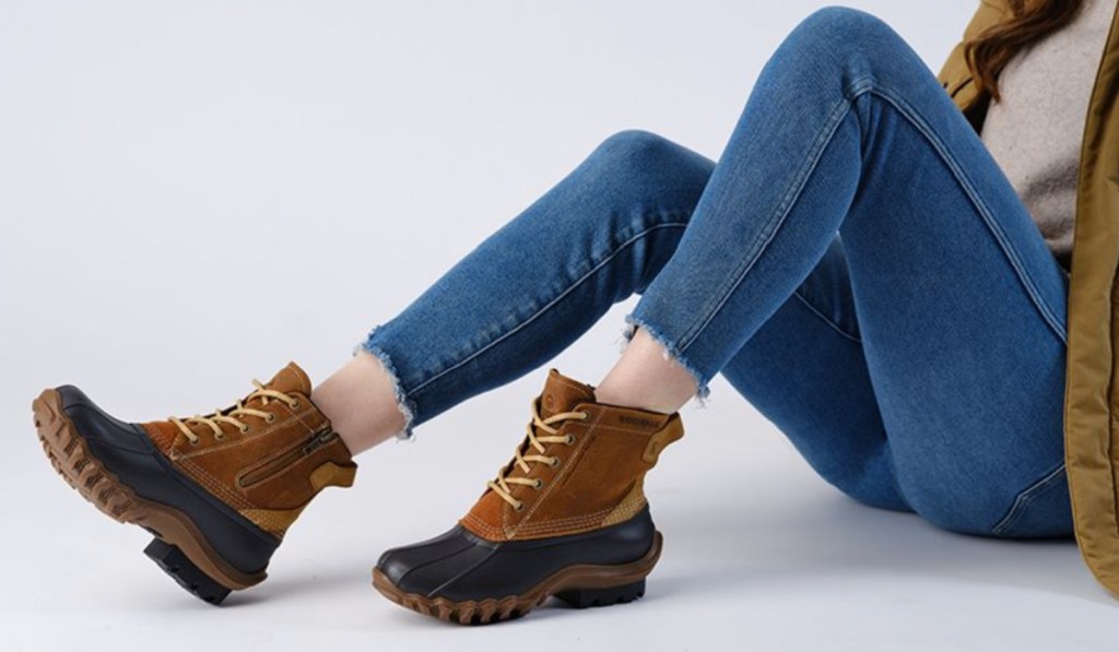 woman sitting wearing brown duck boots