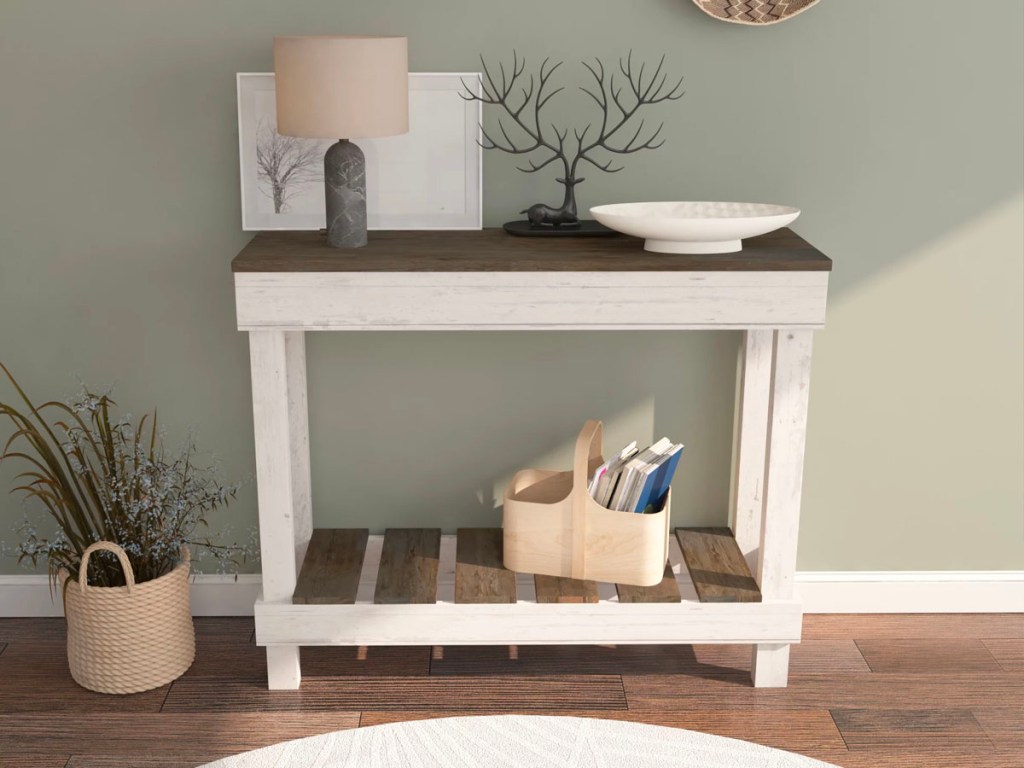 white sofa table with lamp, plate and decor