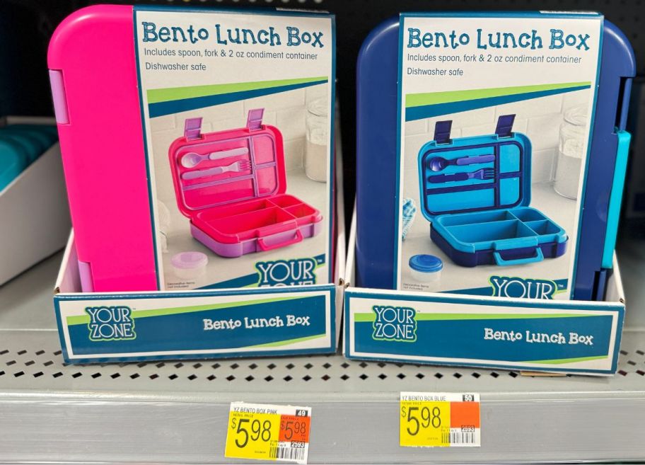 A pink bento box next to a blue bento box on a walmart store shelf 