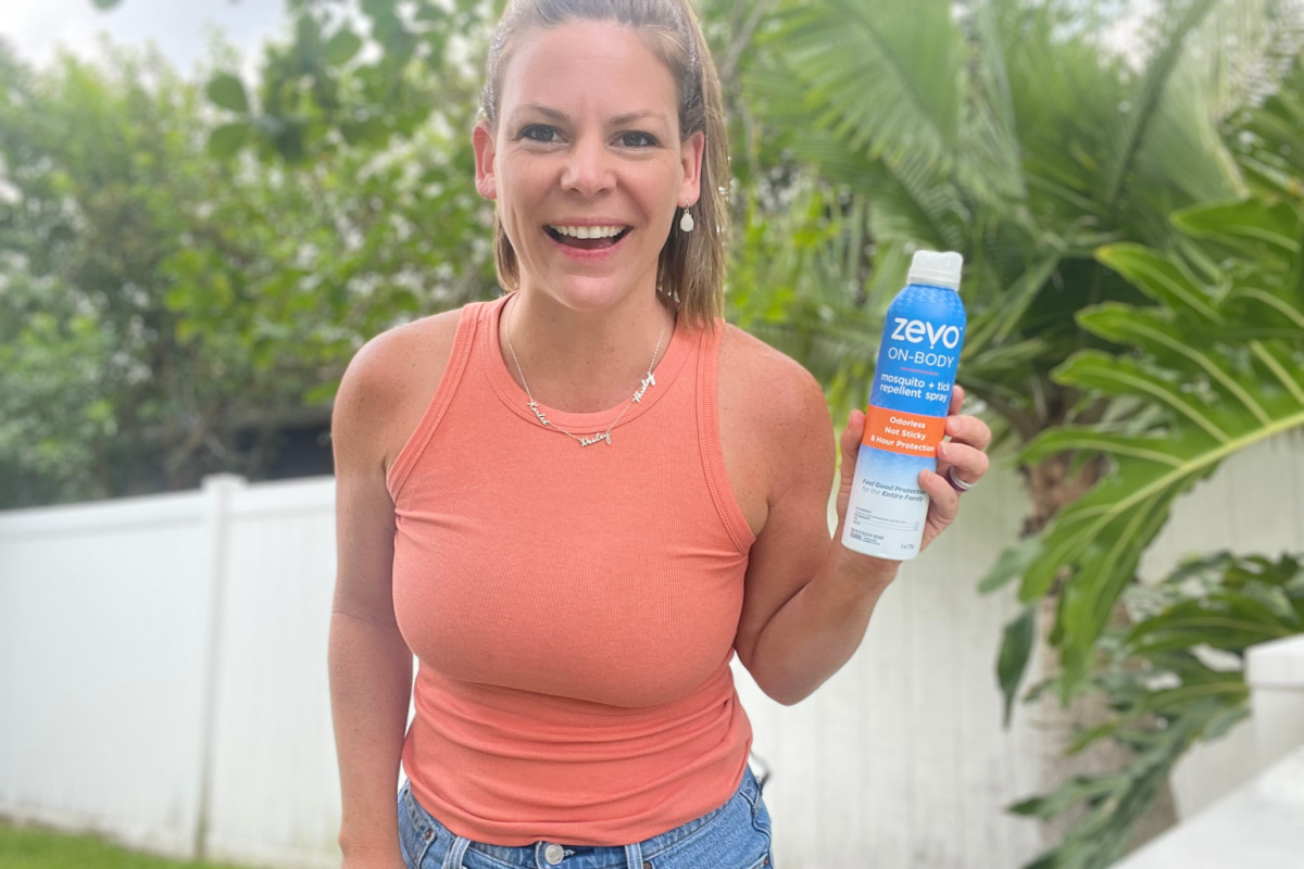 woman holding bug spray can outside