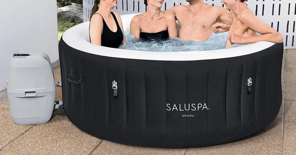 Bestway Miami SaluSpa Inflatable Hot Tub in Black shown with people sitting in it smiling