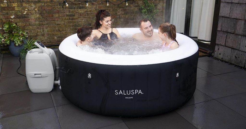 Bestway Miami SaluSpa Inflatable Hot Tub in Black shown with family sitting in it