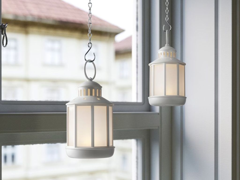 lighted white lanterns hanging in window