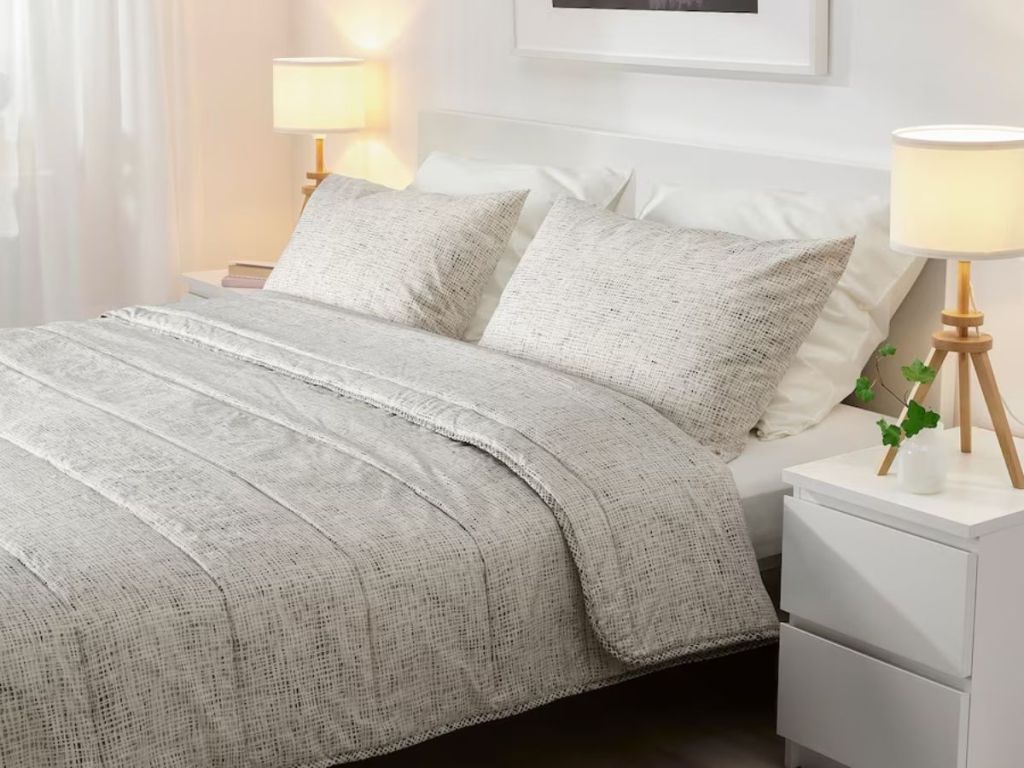 grey and white strip comforter and pillowcases on bed