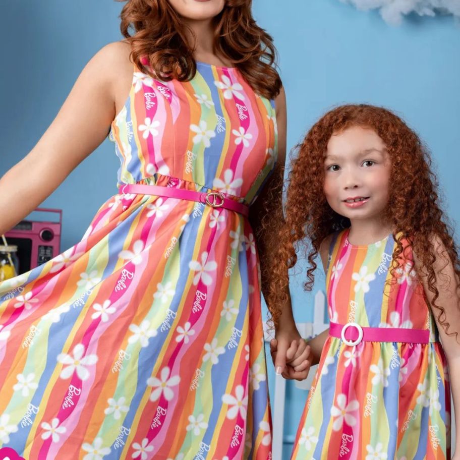 mom and little girl wearing matching rainbow floral print Barbie dresses