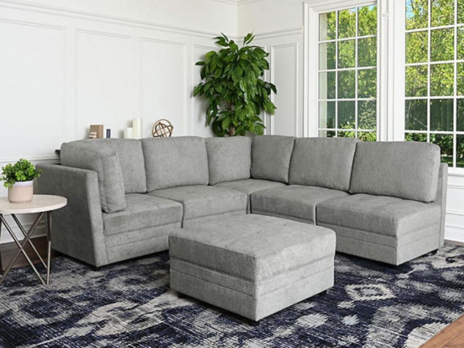 large grey sectional sofa with ottoman in living room