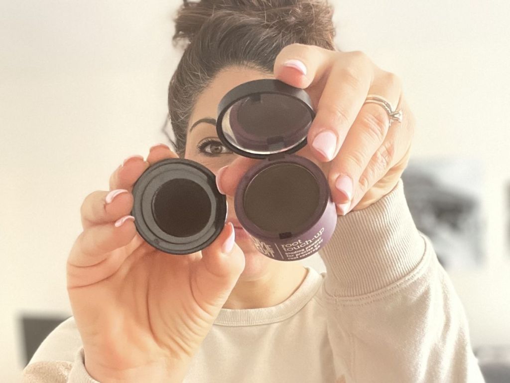 Woman showing a Style Edit Root Touch up container opened with the sponge applicator