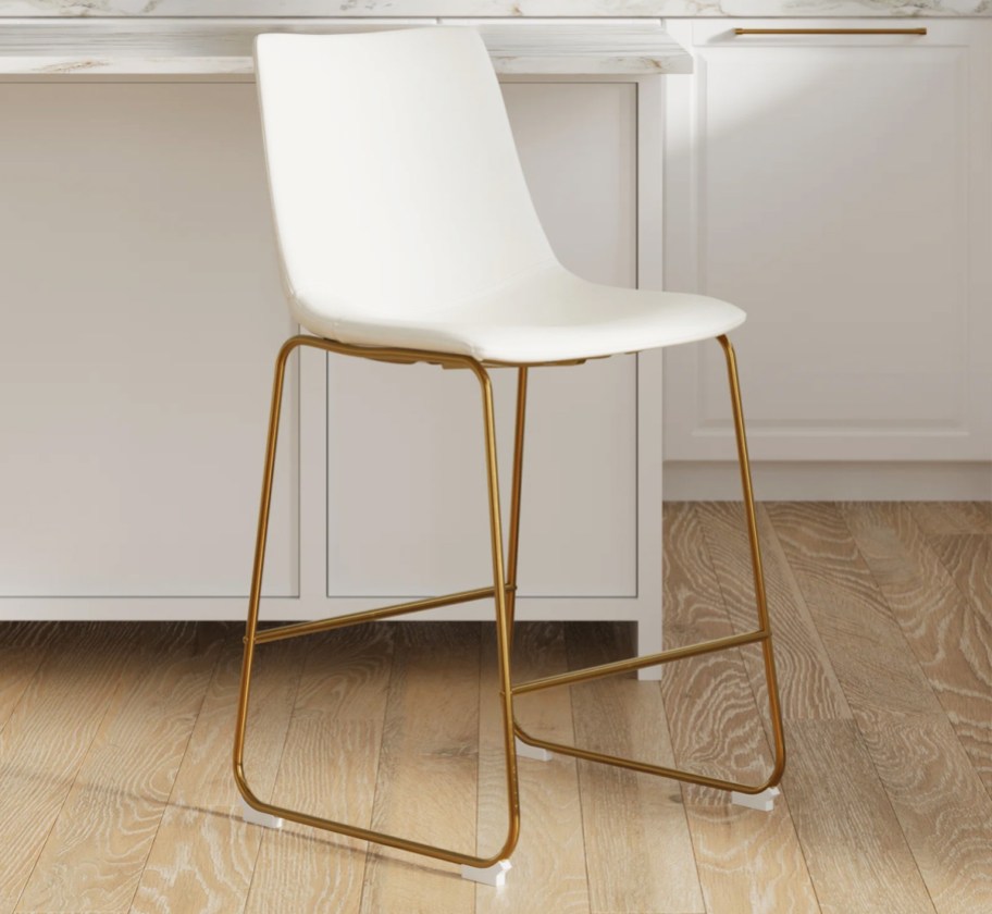 white counter stool with gold legs