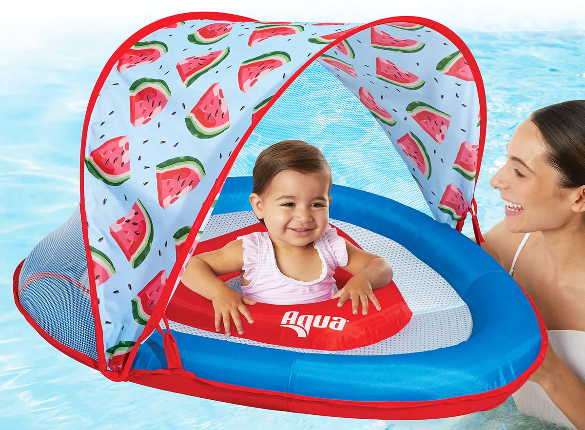 baby in a pool float with watermelon canopy