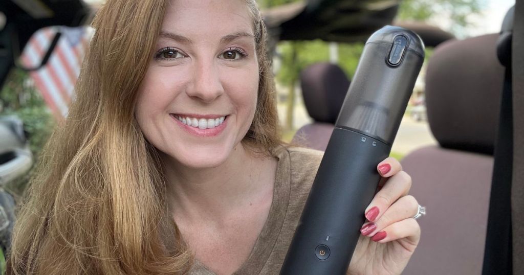 woman holding 4-in-1 car vacuum cleaner