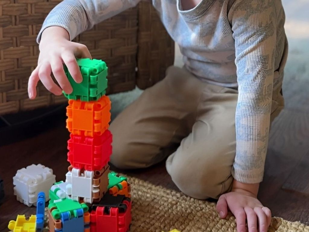 Child using beblox to make stacking blocks