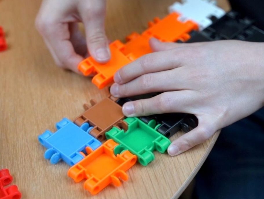 Child using beblox building blocks