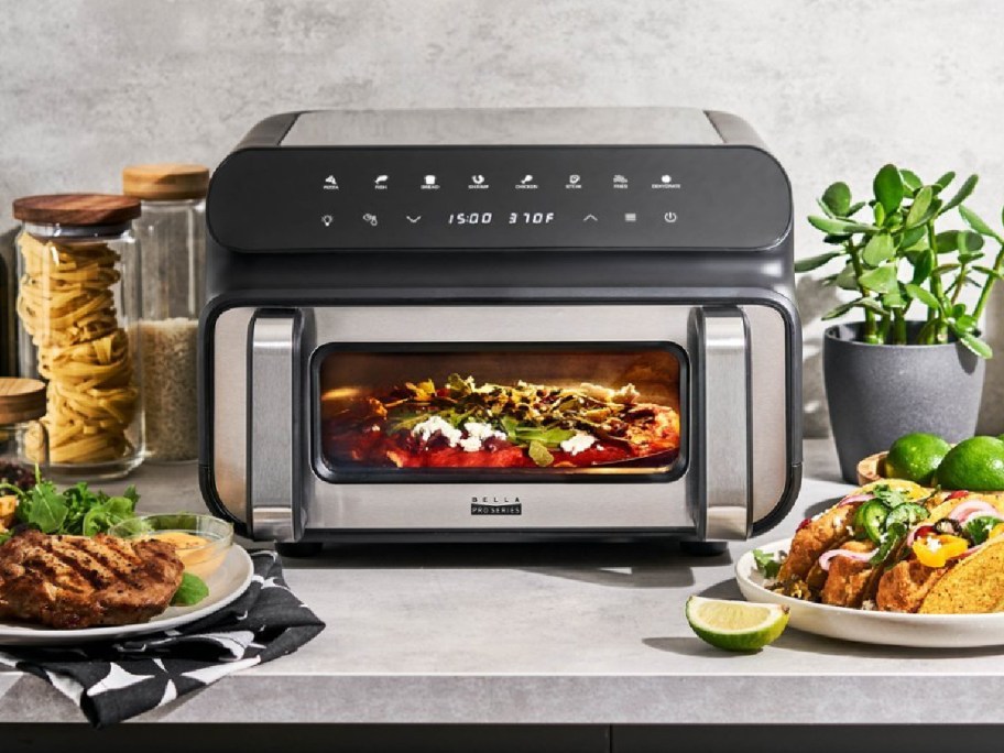 Bella Pro Series 10.5qt 5-in-1 Indoor Grill and Air Fryer displayed with food around it