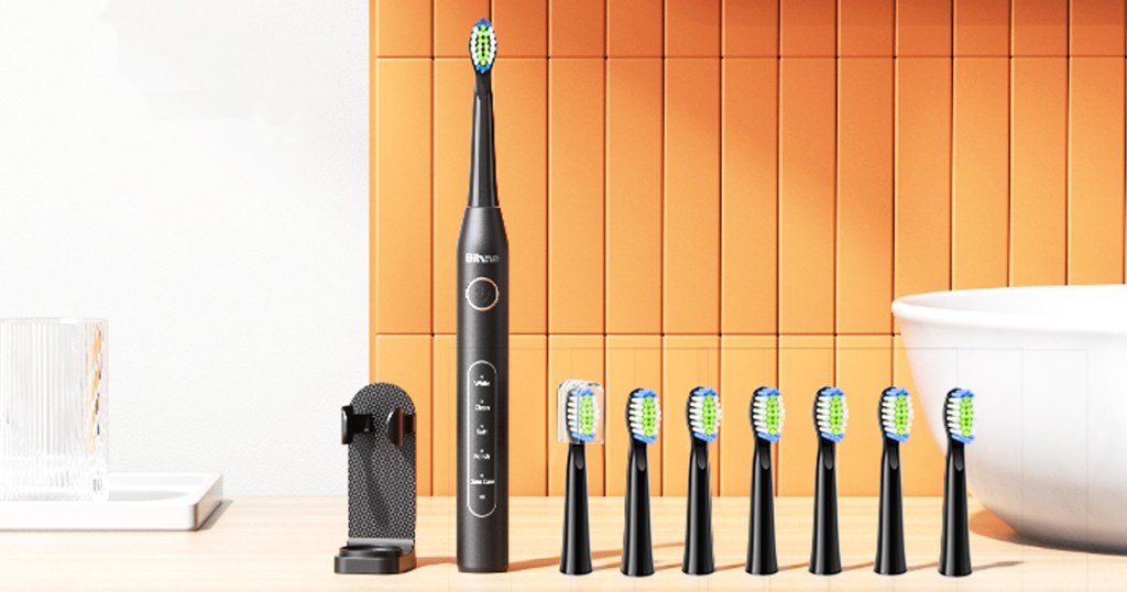 black electric toothbrush with 8 brush heads and stand on bathroom counter