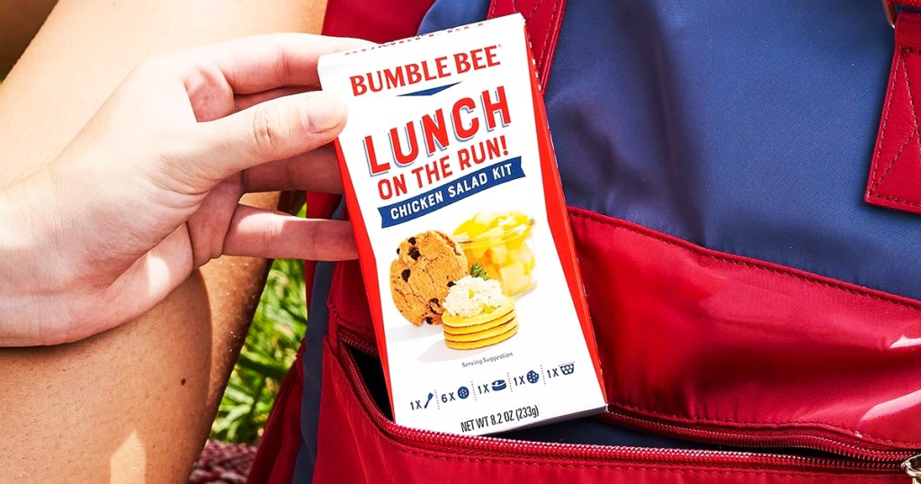 hand grabbing Bumble Bee Lunch On The Run Chicken Salad Kit from backpack pocket