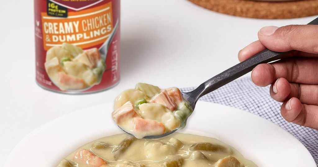 can of campbells chunky creamy chicken dumplings soup behind bowl of soup