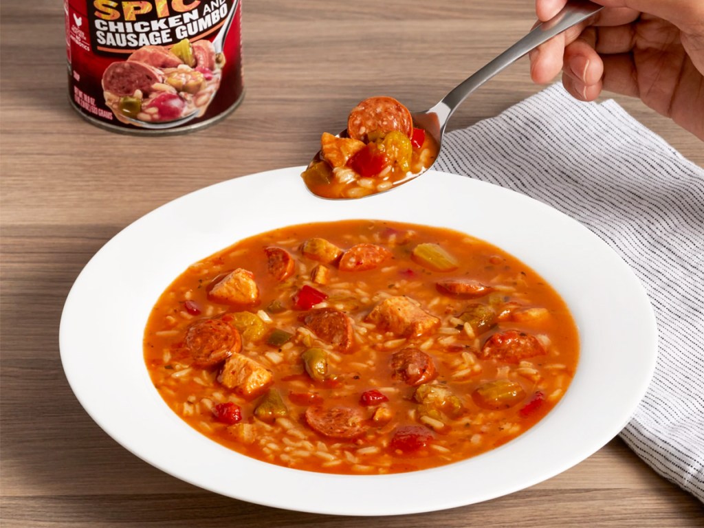 person eating bowl of Campbell's Chunky Soup Spicy Chicken and Sausage Gumbo