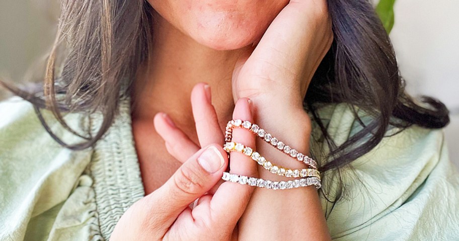 woman wearing rose, yellow, and white gold tennis bracelets