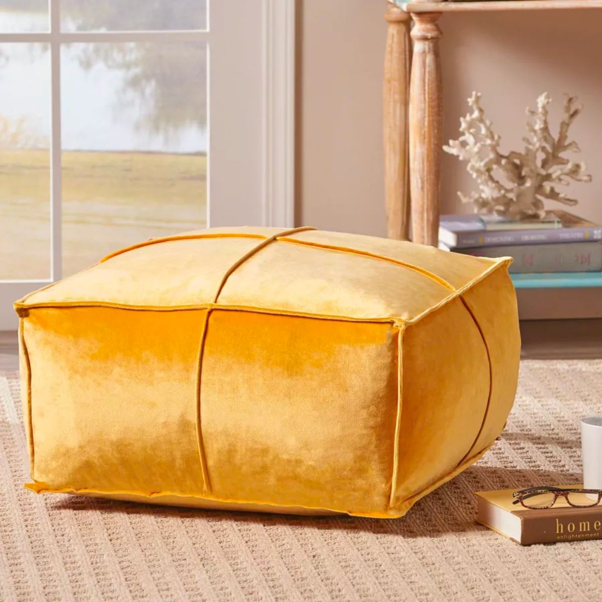 Christopher Knight Home Nakisha Velvet Square Bean Bag Ottoman in honey yellow on a rug in front of a window