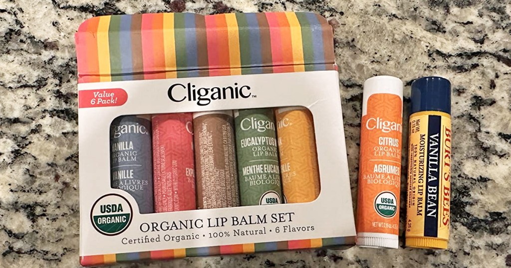 Cliganic Organic Lip Balm Set on counter next to burt's bees lip balm
