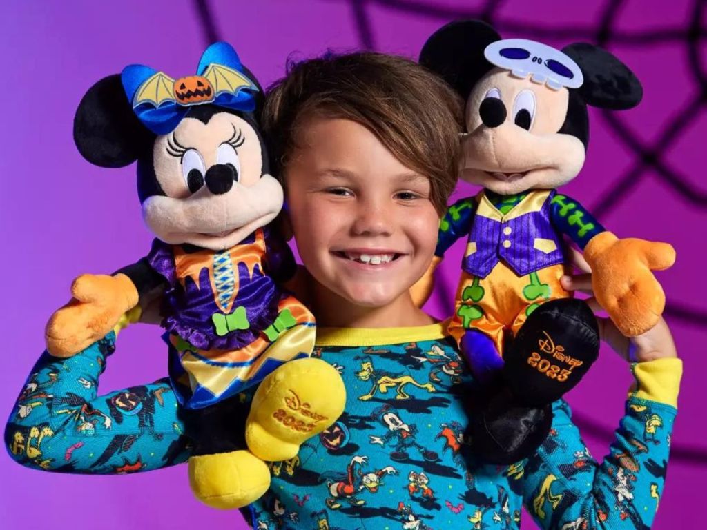 Little boy with Mickey and Minnie Mouse Halloween Plush on his shoulders