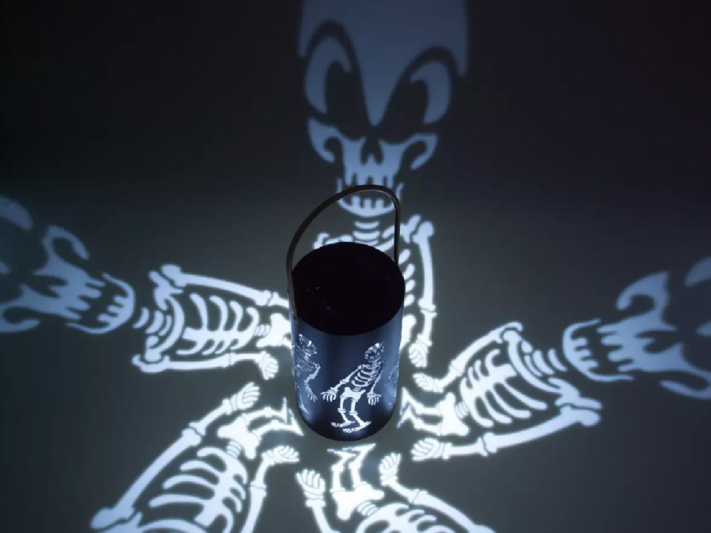 Disney Skeleton Lantern lit up on black background