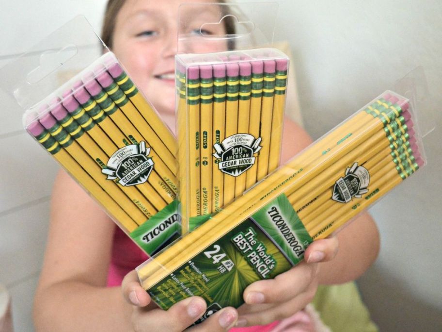 Girl holding 3 packs of Dixon Ticonderoga Pencils