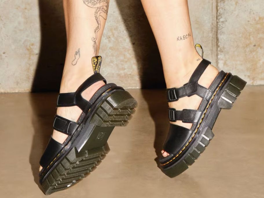 Woman's feet on tip-toes wearing Dr. Martens Ricki Nappa Lux Leather 3-Strap Platform Sandals