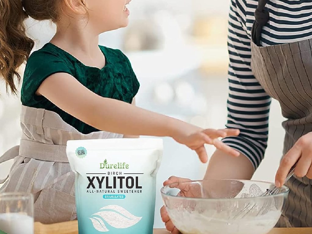 DureLife Birch XYLITOL Sugar Substitute bag next to girl who's making treats with her parent
