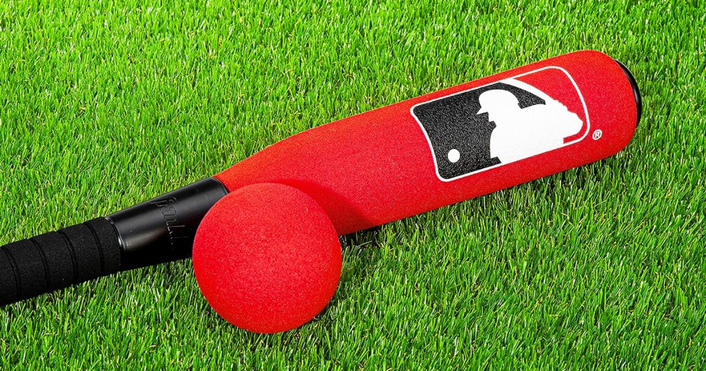 red foam baseball bat and ball on grass