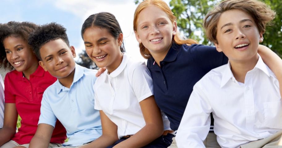 Kids sitting together wearing French Toast uniforms in different colors