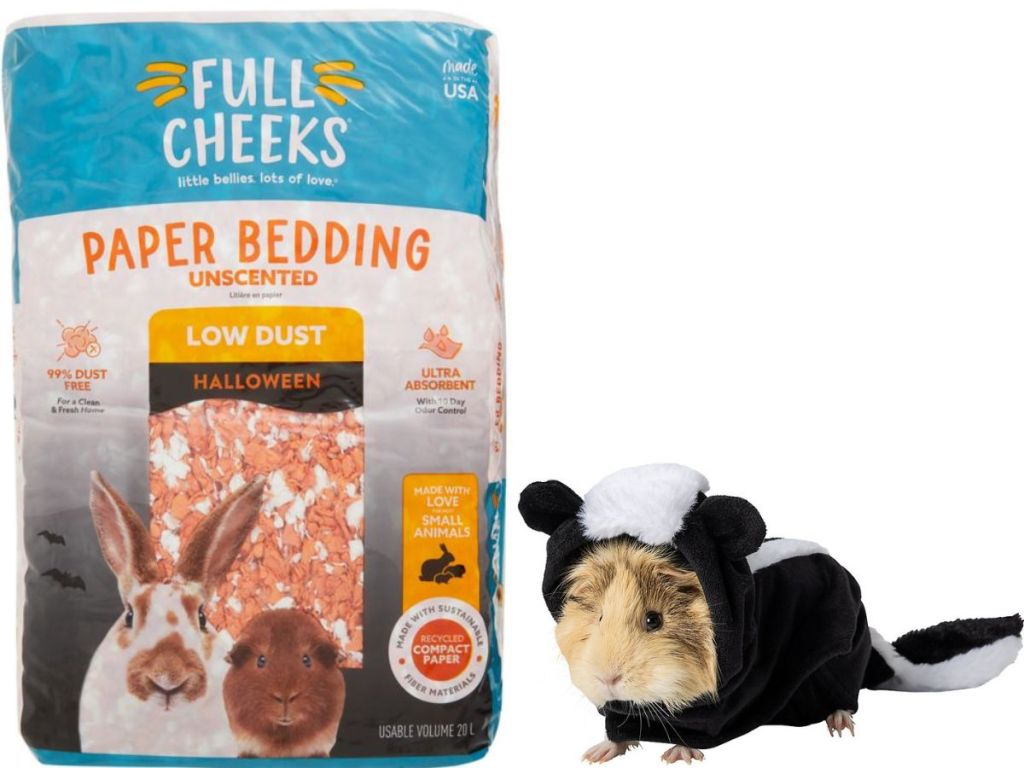 A bag of Halloween small pet paper bedding and a guinea pig wearing a skunk costume
