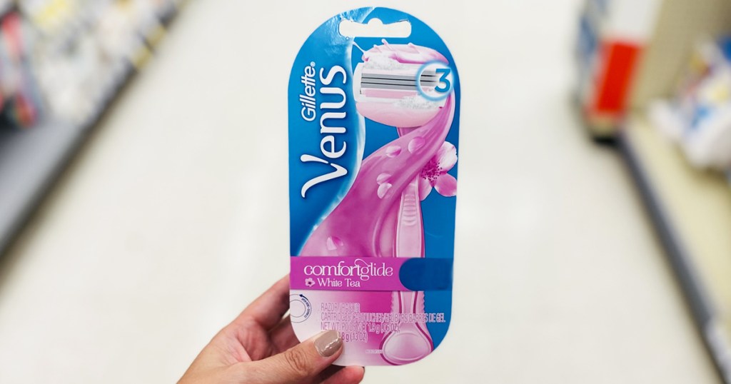 hand holding a pack of gillette venus razors