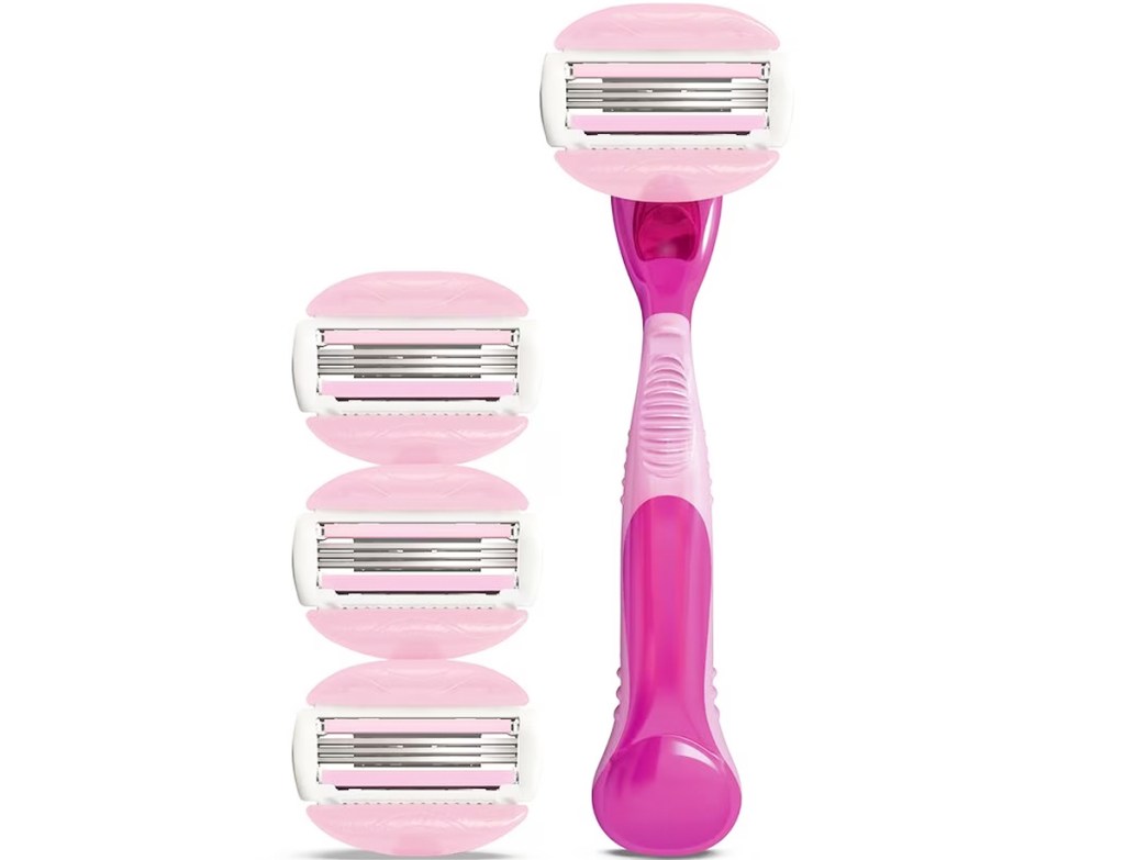 pink and white razor and three replacement heads