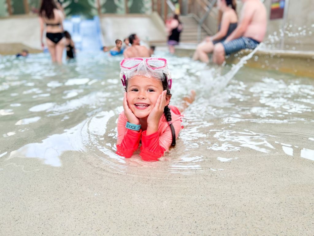 little girl laying down in wading pool