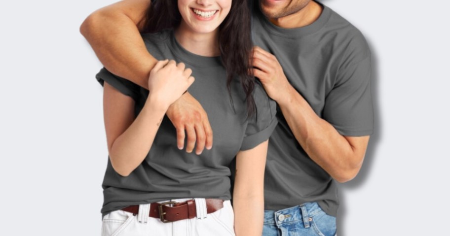 women and man wearing grey tshirts, hugging and laughing