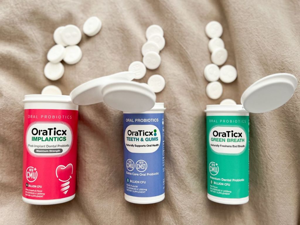 3 bottles of different types of Oratricx Oral Care Probiotics open with tablets spilling out