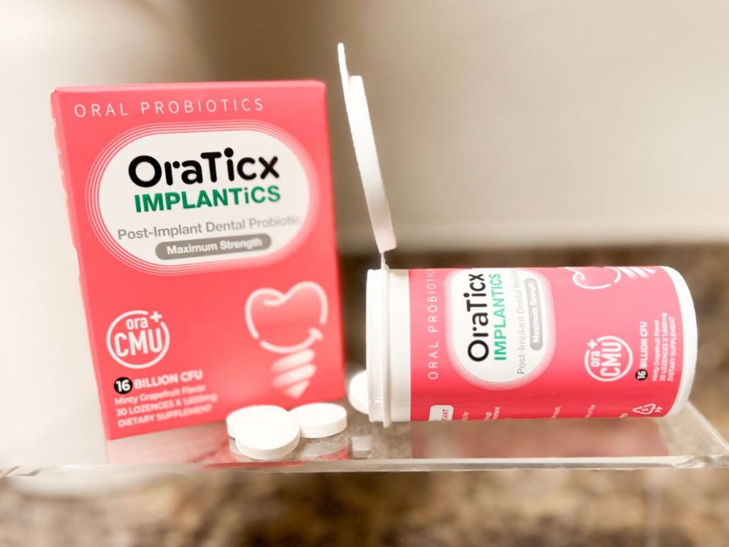 box of OraTicx Implantics Oral Probiotics - Dental Implant Support with an open bottle and tablets spilling out