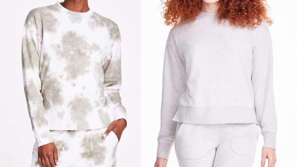 two women in crewneck sweatshirts