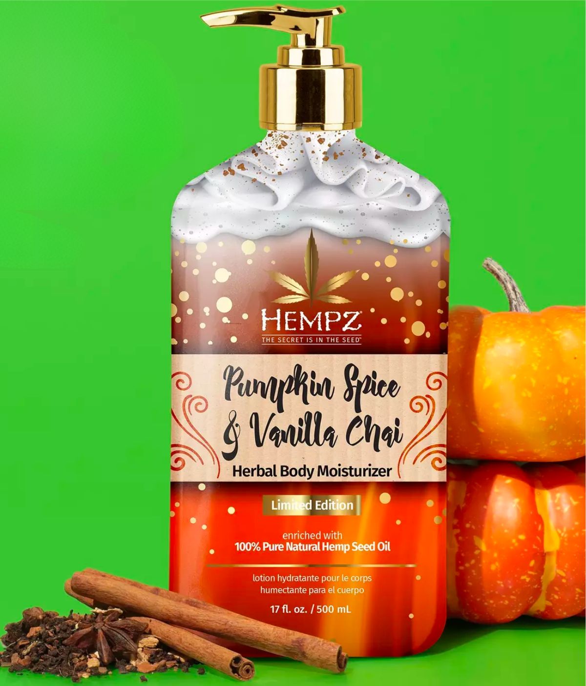 a pump bottle of Hempz pumpkin chai and vanilla body lotion pictured with mini pumpkins, and chai spices