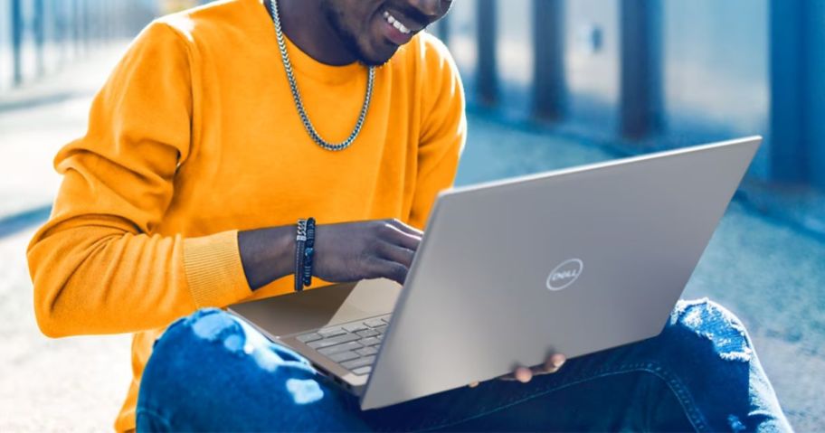 Young man sitting outside using a Dell Laptop