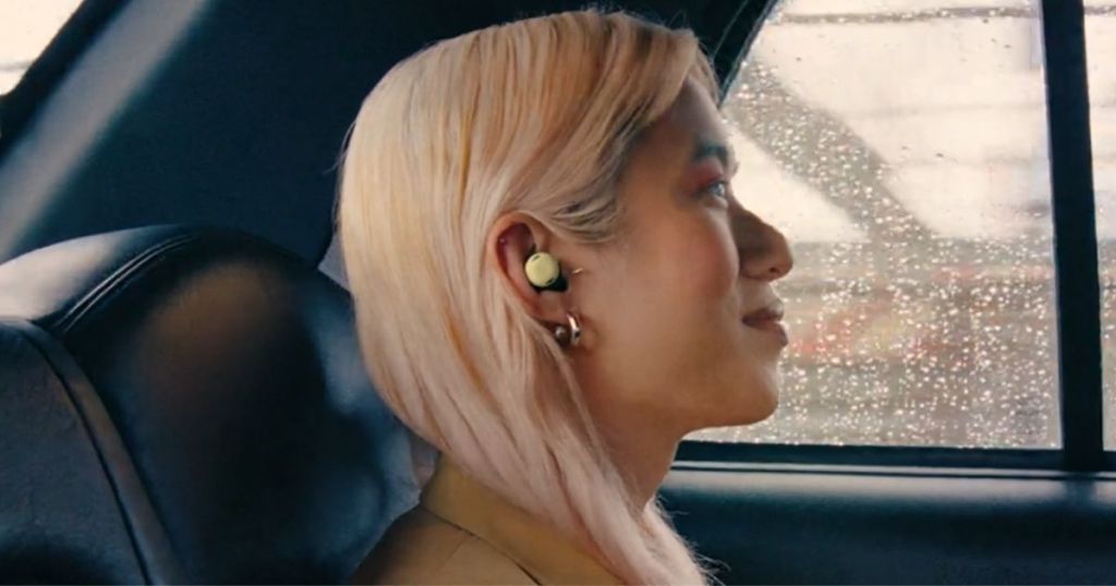 woman riding in taxi wearing a pair of Google Pixel Buds Pro