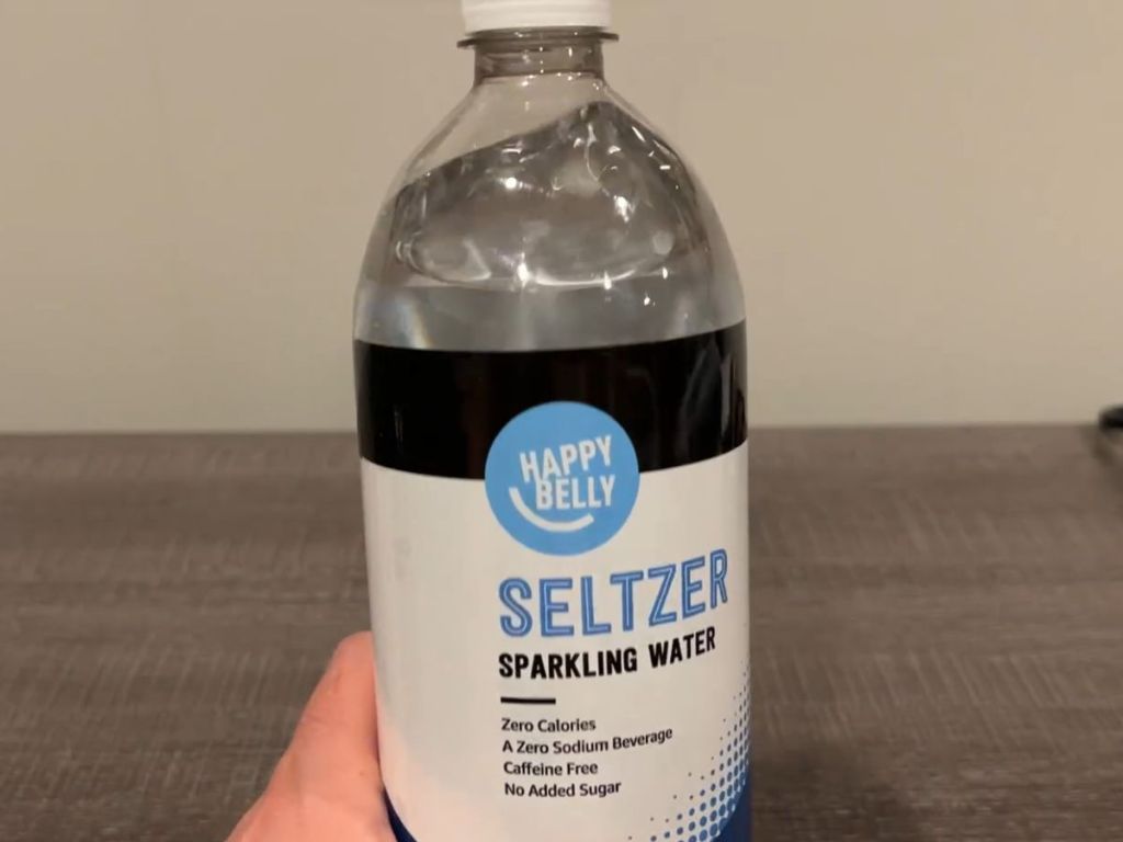 Happy Belly Seltzer Water 1L Bottle shown in man's hand