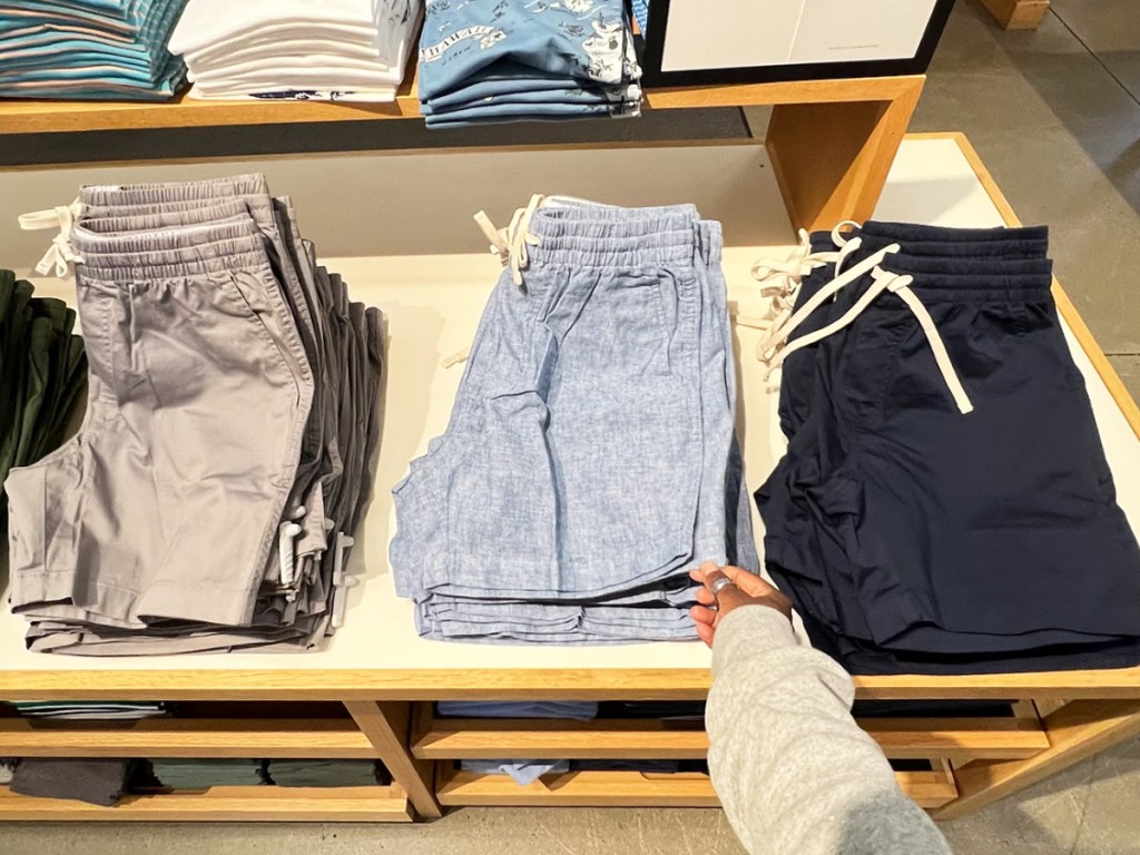 hand touching pair of men's shorts