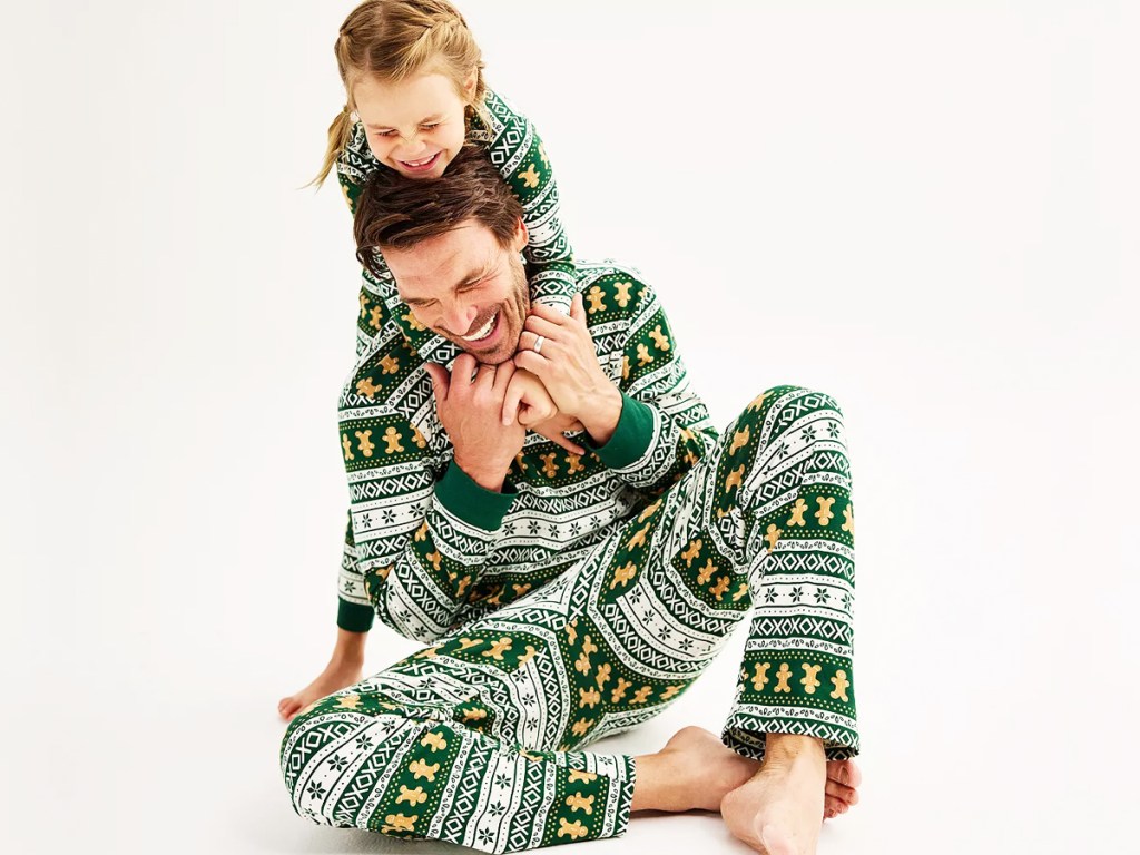 father and daughter wearing matching christmas pajamas