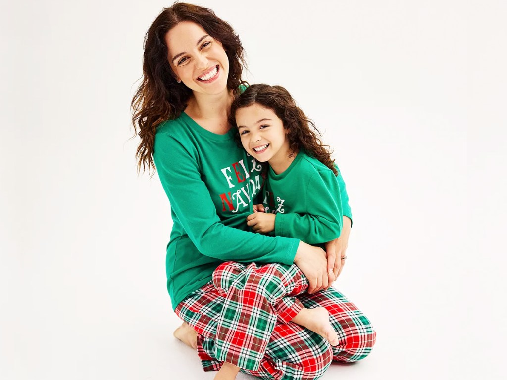 mom and daughter wearing matching christmas pajamas